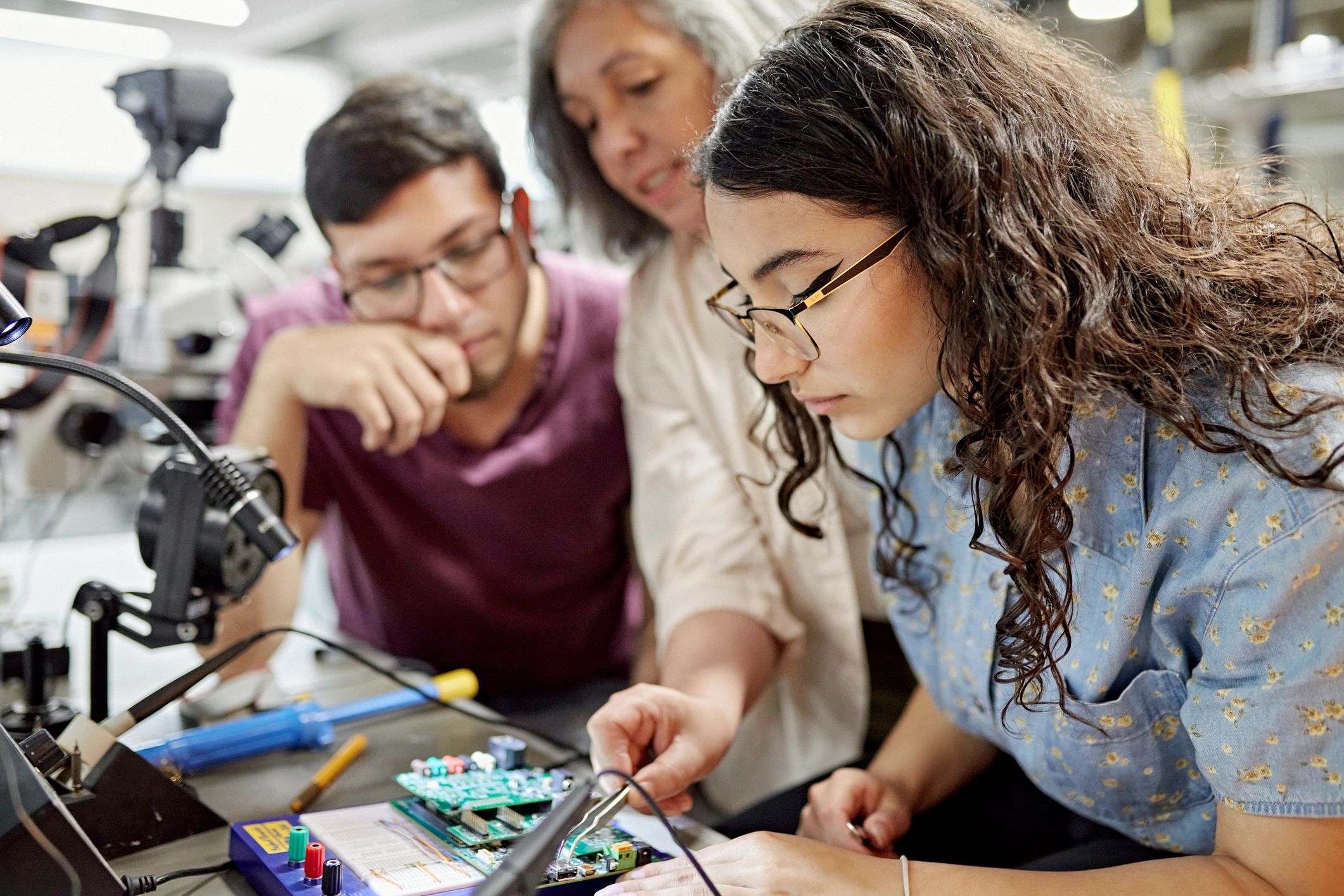 Instructor assisting students with an engineering project